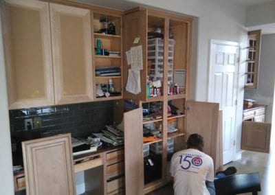 An Image of a Man Refinishing Kitchen Cabinet Doors