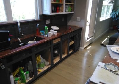 An image of kitchen cabinets without the doors in place